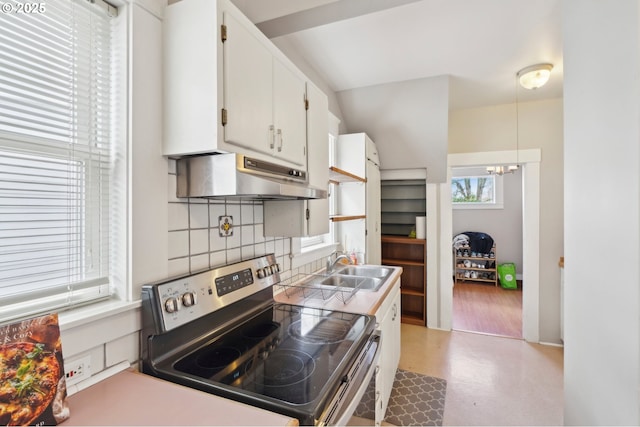 4822 N Vanderbilt St, Portland, OR 97203 - kitchen with electric range, under cabinet range hood, backsplash, a sink, and a chandelier