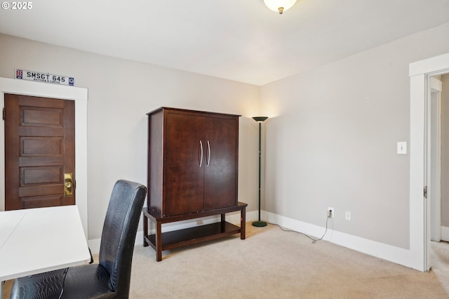 office space featuring light colored carpet and baseboards