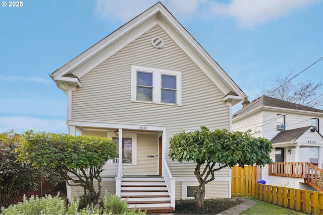 view of front facade featuring covered porch and fence