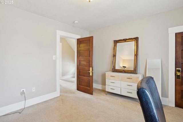 office with baseboards and light carpet