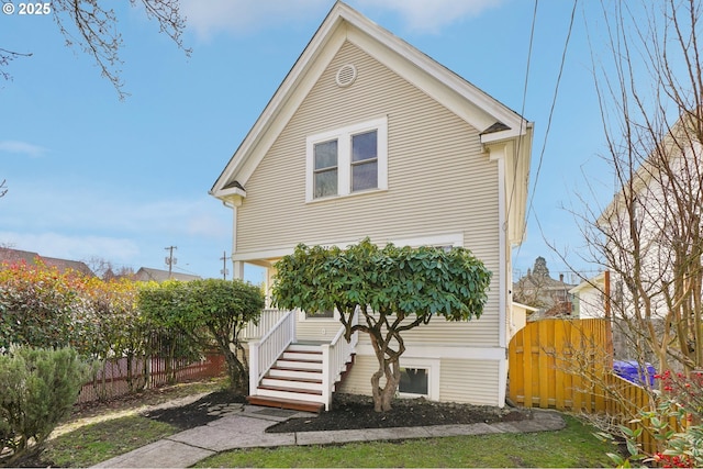 view of front of house with stairway and fence