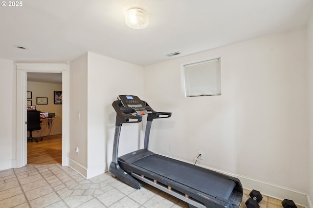 exercise area with visible vents and baseboards