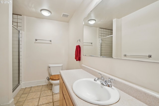 bathroom featuring visible vents, toilet, a shower with door, baseboards, and vanity