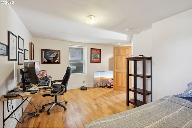 office space featuring baseboards and wood finished floors