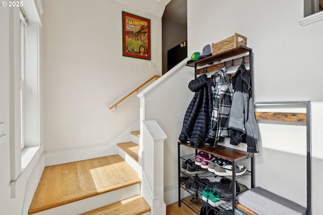 staircase with wood finished floors and baseboards