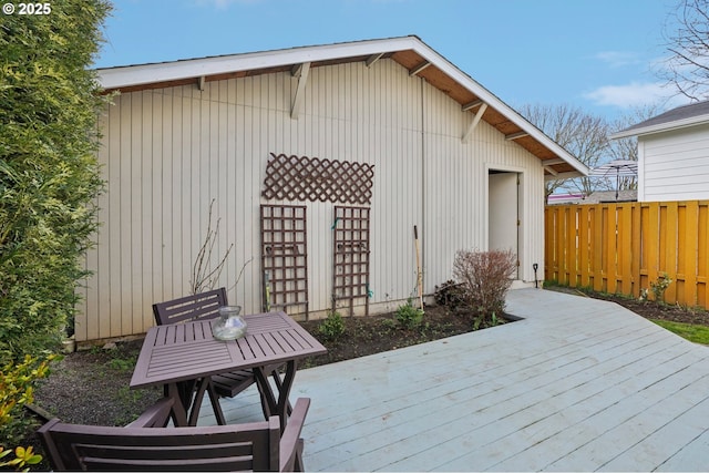 wooden terrace with outdoor dining space and fence