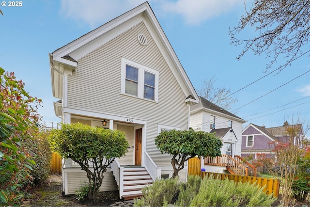 view of front of house featuring fence