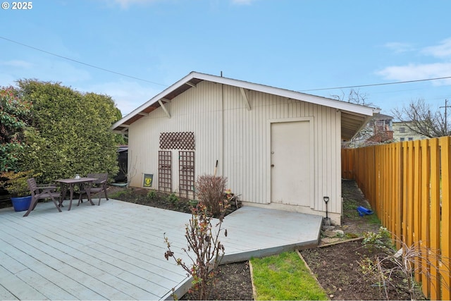 wooden terrace with outdoor dining space and a fenced backyard