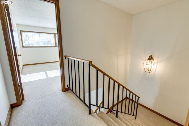7430 SW Greens View Ct, Wilsonville, OR 97070 - unfurnished room with carpet floors, a textured ceiling, and baseboards