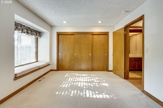 7430 SW Greens View Ct, Wilsonville, OR 97070 - unfurnished bedroom featuring a closet, carpet floors, baseboards, recessed lighting, and a textured ceiling