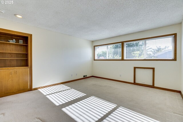 7430 SW Greens View Ct, Wilsonville, OR 97070 - carpeted spare room with a textured ceiling and baseboards