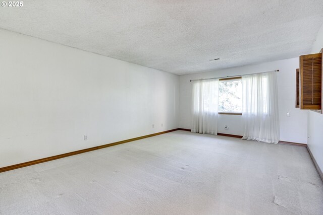 7430 SW Greens View Ct, Wilsonville, OR 97070 - spare room with light colored carpet, a textured ceiling, and baseboards