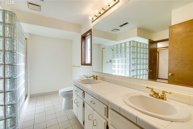7430 SW Greens View Ct, Wilsonville, OR 97070 - bathroom with tiled shower, tile patterned flooring, double vanity, and toilet