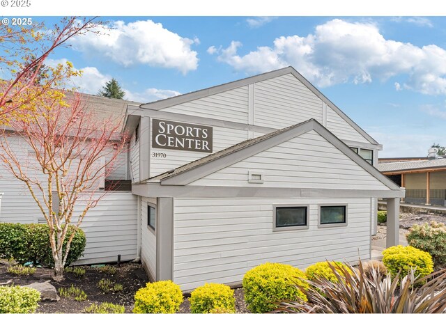 7430 SW Greens View Ct, Wilsonville, OR 97070 - view of property exterior featuring stone siding and a patio area