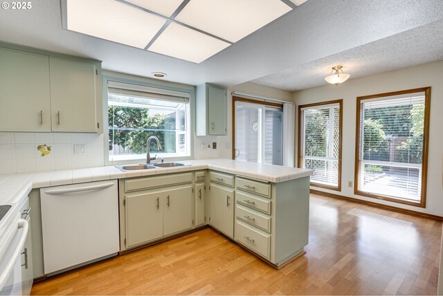 7430 SW Greens View Ct, Wilsonville, OR 97070 - kitchen with white refrigerator with ice dispenser, tile countertops, green cabinetry, and light wood-style floors