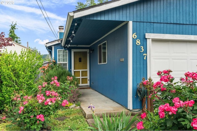 doorway to property with an attached garage