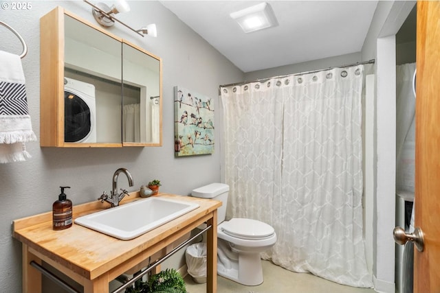 bathroom with toilet, washer / clothes dryer, vanity, and a shower with shower curtain