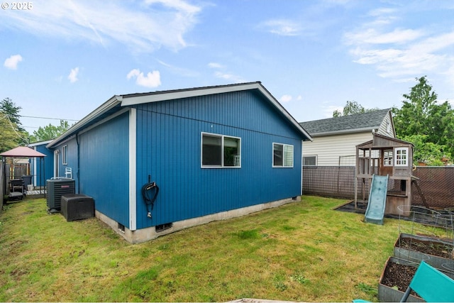 view of property exterior with a garden, central AC, and a playground