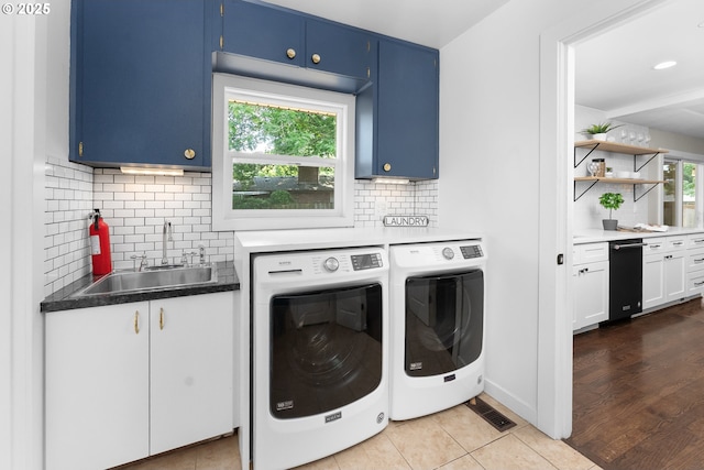 14255 NE Brazee St, Portland, OR 97230 - washroom featuring cabinet space, independent washer and dryer, and light tile patterned floors