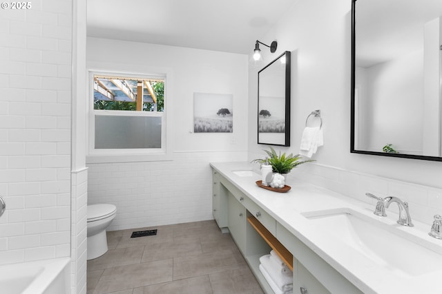 14255 NE Brazee St, Portland, OR 97230 - full bath featuring double vanity, tile walls, tile patterned flooring, wainscoting, and tub / shower combination
