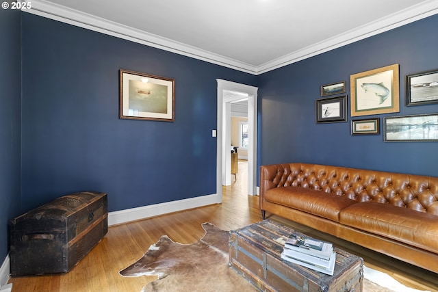 living room with crown molding, wood finished floors, and baseboards