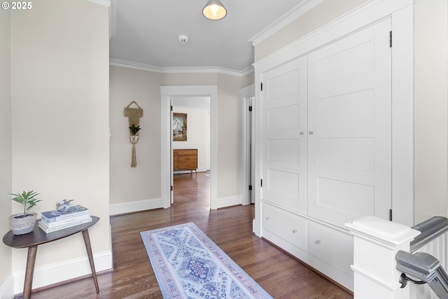 hallway featuring ornamental molding, baseboards, and wood finished floors