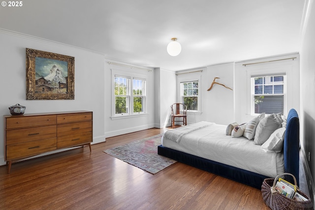 bedroom featuring wood finished floors and baseboards
