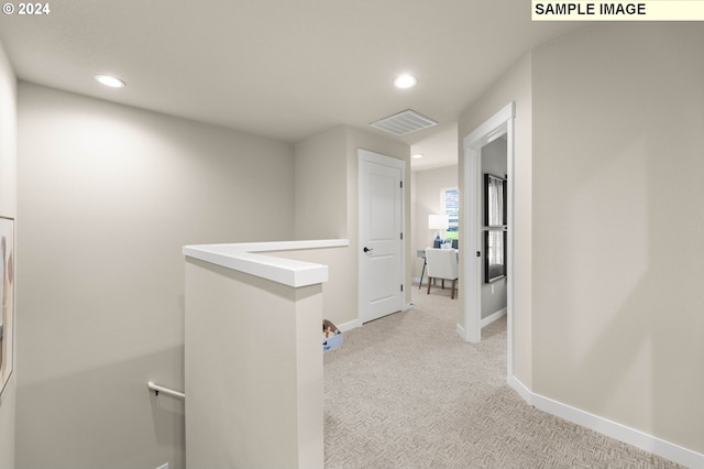 hallway with light colored carpet