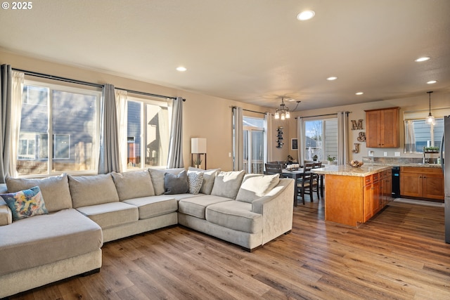 living area featuring recessed lighting, dark wood-style flooring, and an inviting chandelier