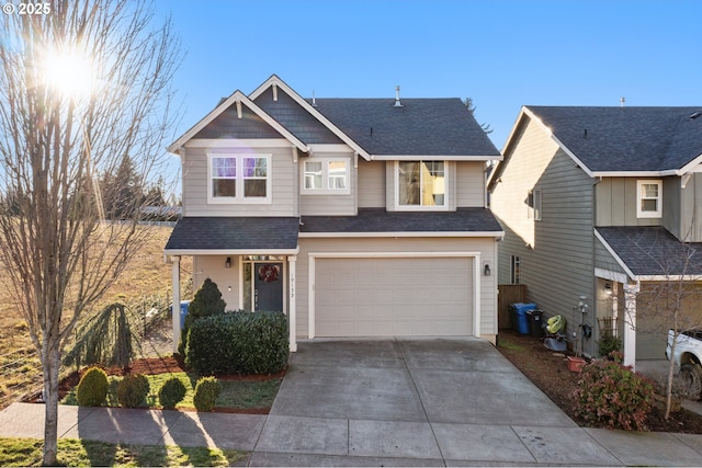 craftsman-style home featuring driveway, a shingled roof, and a garage