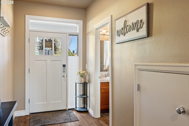 entryway with a textured wall and wood finished floors