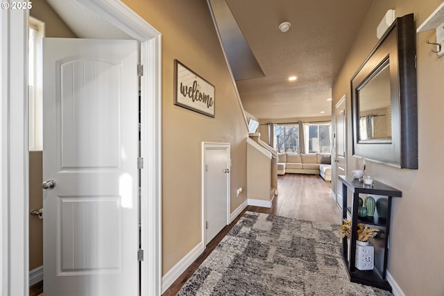 hall with wood finished floors and baseboards