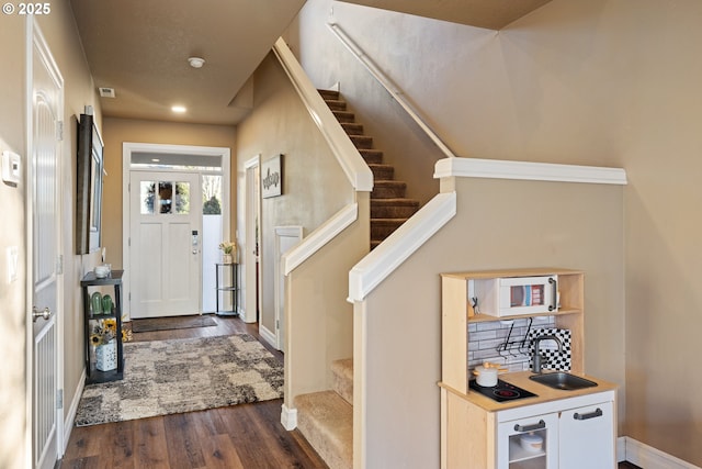 living room featuring baseboards, a tiled fireplace, stairway, wood finished floors, and recessed lighting