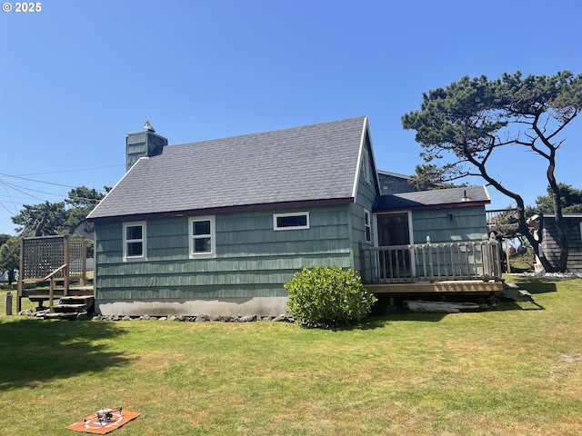 5870 Floyd Ave, Cloverdale, OR 97112 - view of property exterior featuring a yard, a wooden deck, a shingled roof, and a chimney