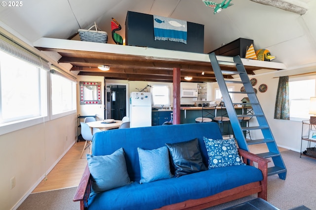 5870 Floyd Ave, Cloverdale, OR 97112 - living room featuring lofted ceiling, a wealth of natural light, and baseboards
