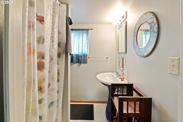 5870 Floyd Ave, Cloverdale, OR 97112 - bathroom featuring baseboards and a shower with curtain