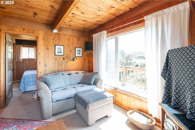 5870 Floyd Ave, Cloverdale, OR 97112 - living area with beamed ceiling, carpet flooring, wood walls, and wooden ceiling
