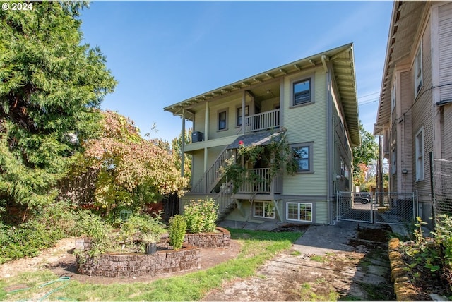 back of property with a balcony