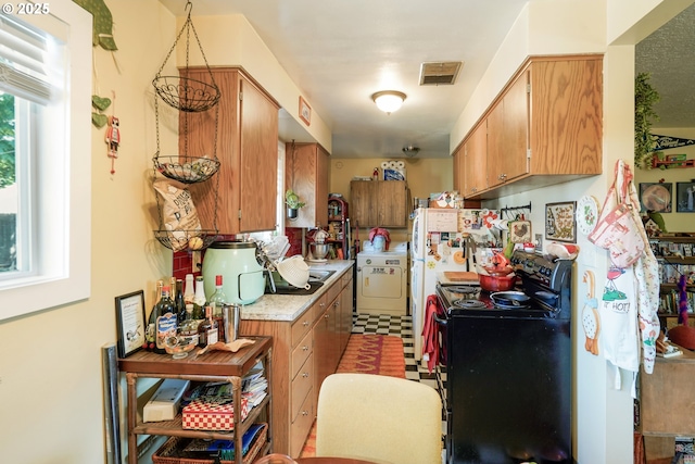 1304 NE 79th Ave, Portland, OR 97213 - kitchen featuring black electric range, washer / clothes dryer, light countertops, and brown cabinets