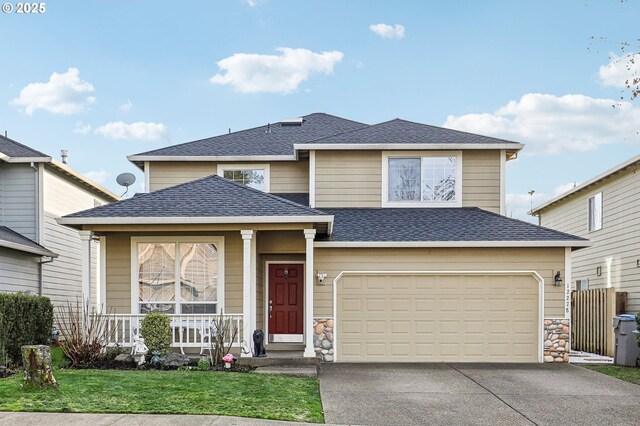 view of front of home featuring a garage, a front lawn, and a porch