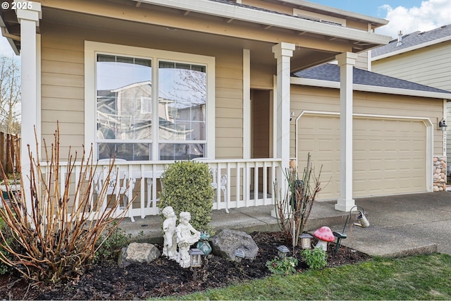 view of exterior entry with a porch and a garage