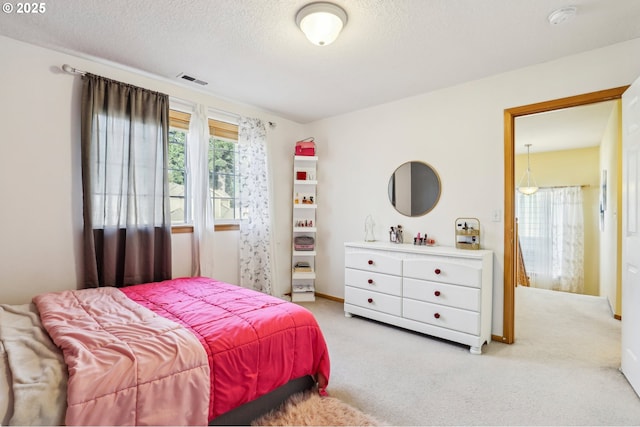 carpeted bedroom with a textured ceiling