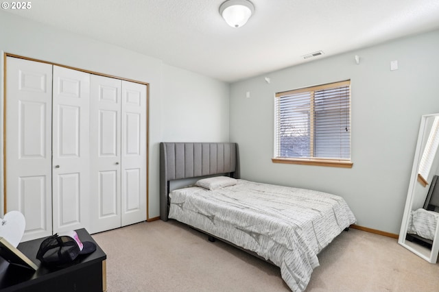 carpeted bedroom featuring a closet