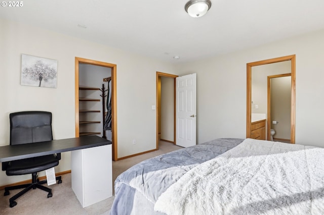 bedroom with a spacious closet and light carpet