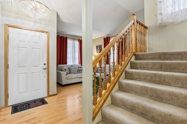 entrance foyer with wood-type flooring and a chandelier