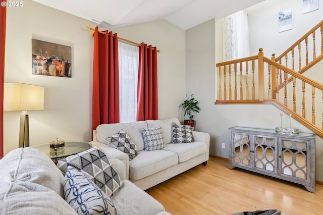 living room featuring lofted ceiling and hardwood / wood-style floors