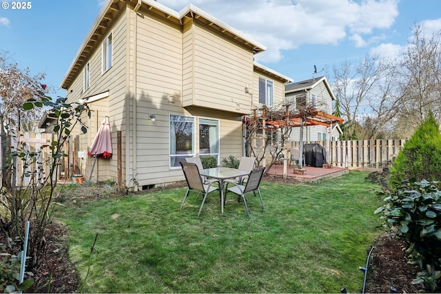 back of house featuring a yard and a patio