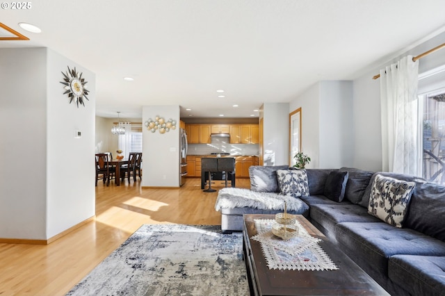 living room with a healthy amount of sunlight and light hardwood / wood-style floors