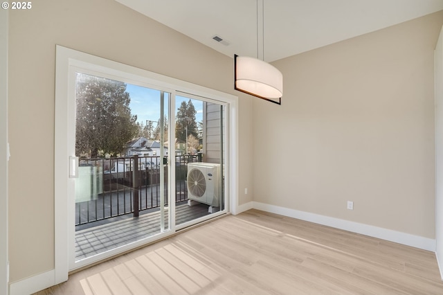 unfurnished dining area with wood finished floors, visible vents, and baseboards