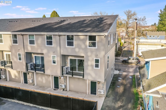 back of property featuring a shingled roof